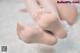 A close up of a baby's feet on a white blanket.