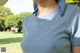 A woman wearing a blue shirt with white spots on it.