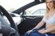 A woman sitting in the driver's seat of a car.